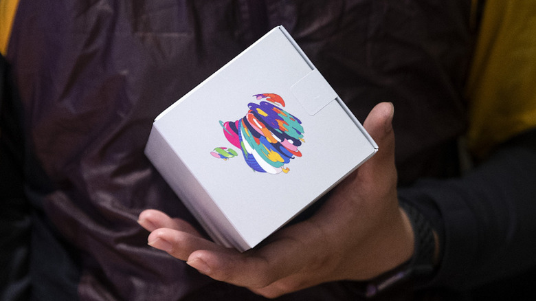 Person holds box with Apple logo