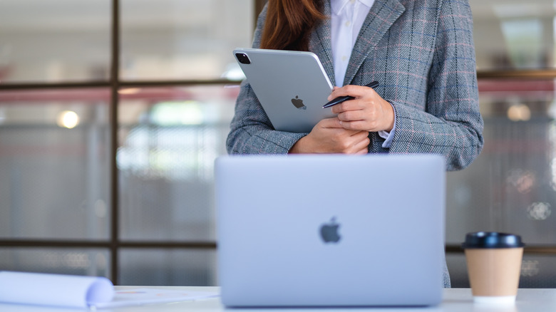 Woman holding an iPad.