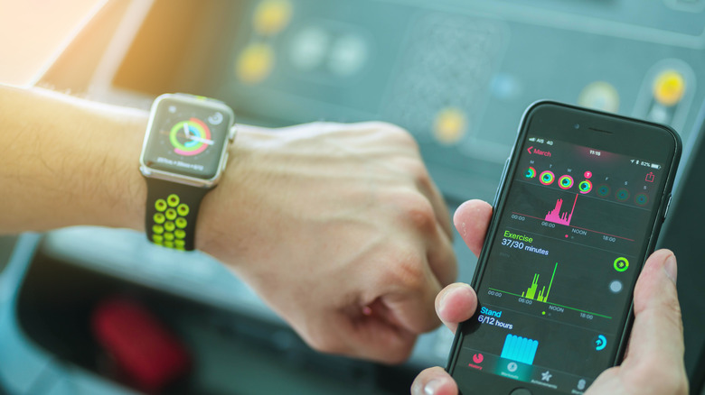 Person using an Apple Watch with an iPhone.