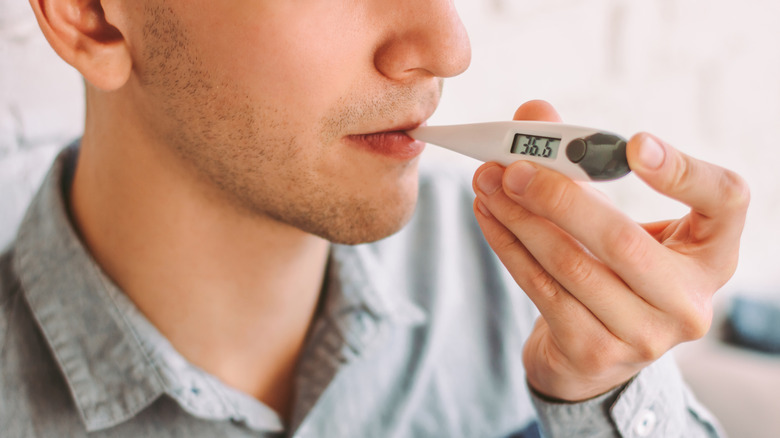 Man using thermometer