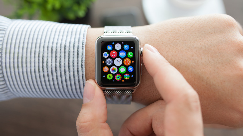 Apple Watch on wrist displaying apps