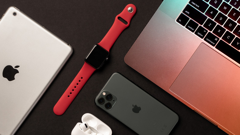 Apple products on black desk