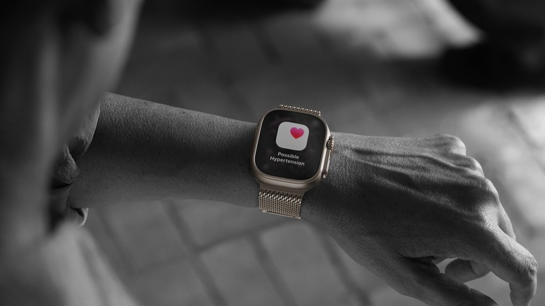 Person wearing Apple Watch Ultra 3 showing possible hypertension alert