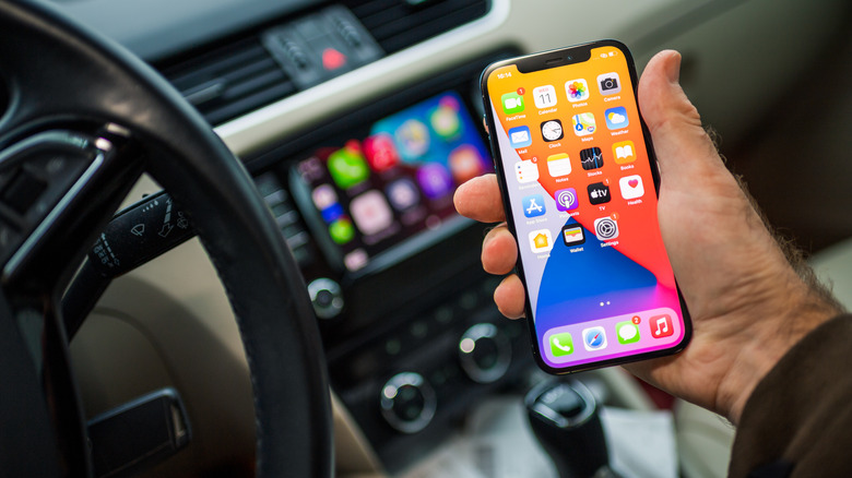 Person using an iPhone inside a car.