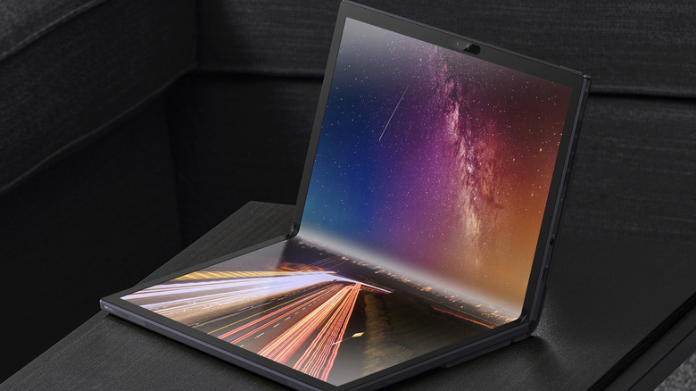 Asus ZenBook Fold OLED laptop lying on a table.