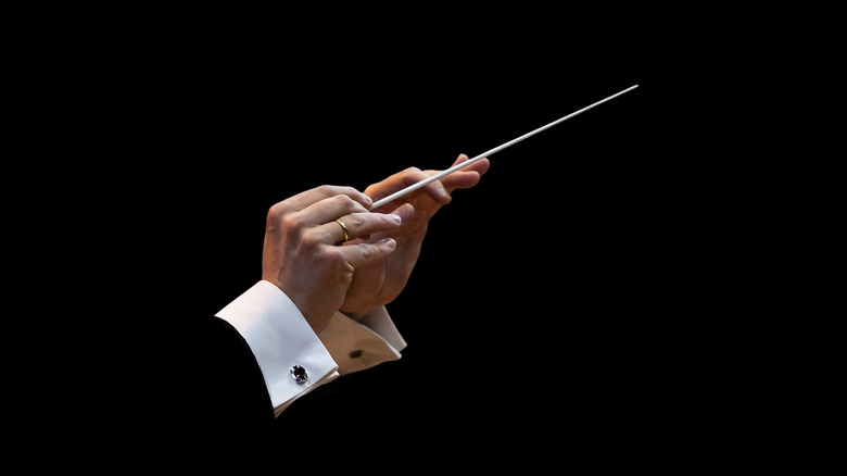 A music composer's hand with wand