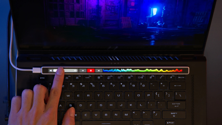 The ENIAC Flexbar customizable touch-bar being used to play and control a video.