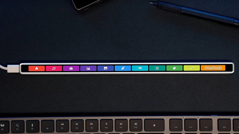 The ENIAC Flexbar customizable touch-bar against a black background with a keyboard at the bottom.
