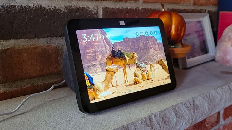 An Amazon Echo Show 8 on a fireplace mantle.