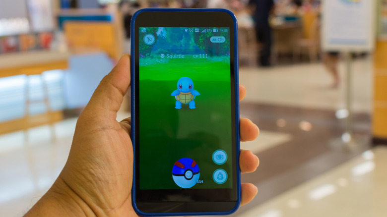 man holding phone with pokemon go