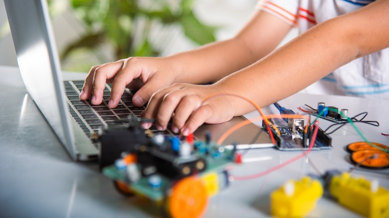 Boy coding Arduino robot