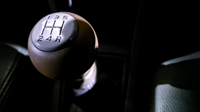 A five-speed manual shifter in an unidentified car