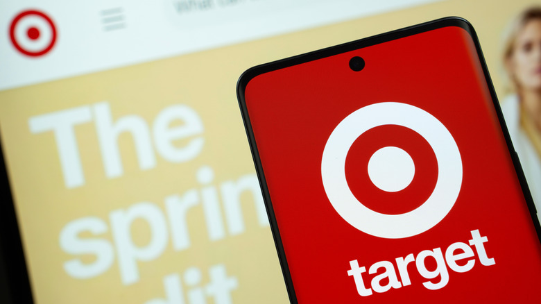 smartphone with target logo on the screen in front of a computer screen with the Target website on it