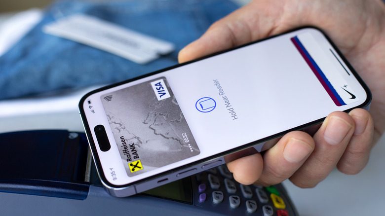 A person paying for their purchase through Apple Pay.
