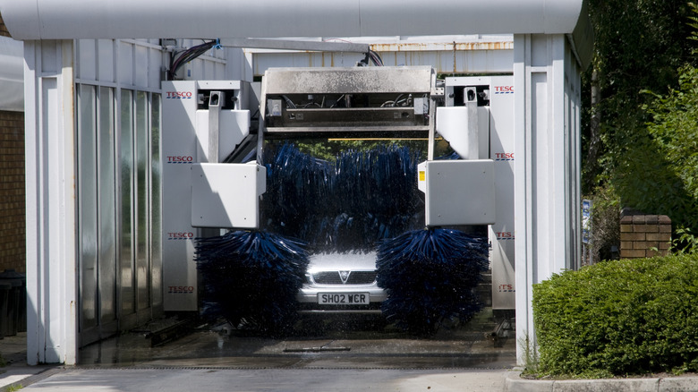 silver car going through an automated car wash