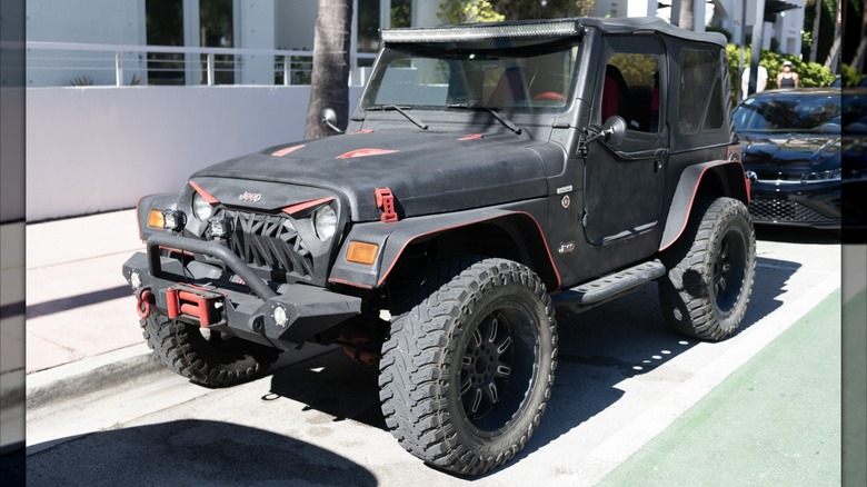 A Jeep Wrangler parked on a city street.