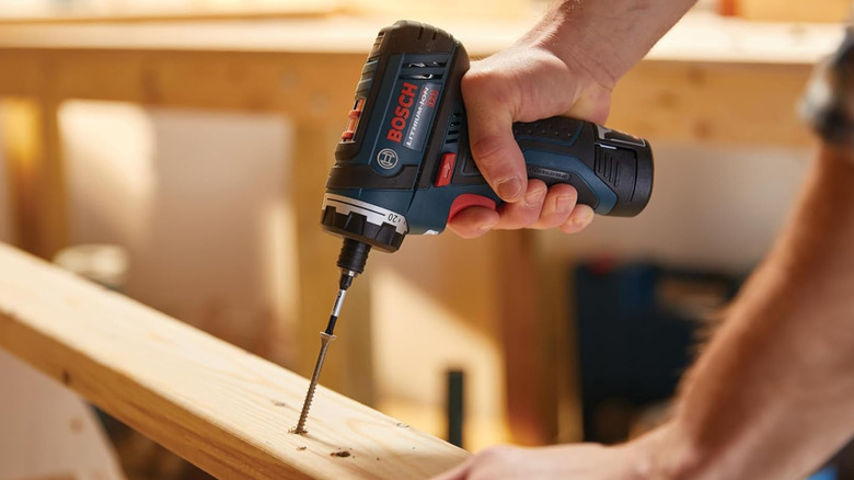 A shot of the Bosch pocket driver used to drive a screw into wood