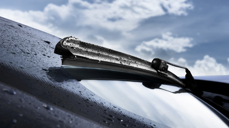 close-up of a windshield wiper in action while it is raining