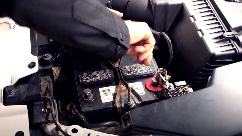 Mechanic installing car battery