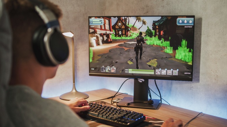 Gamer pictured playing game on desktop monitor