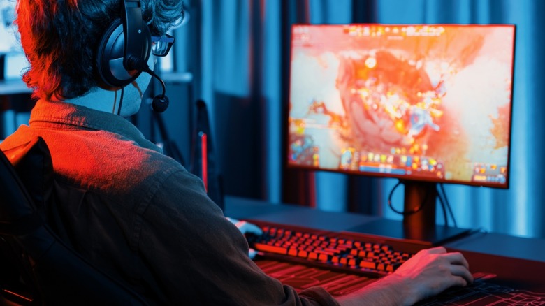 Gamer playing MOBA-style game on a PC monitor