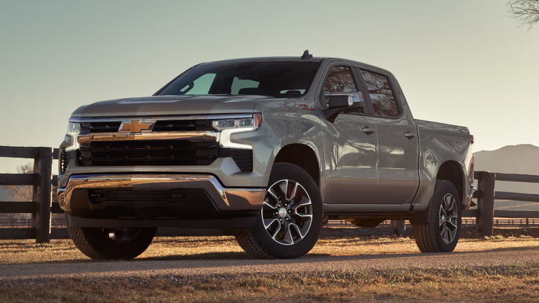 2025 gray Chevrolet Silverado parked on a paved road in the middle of a rural area