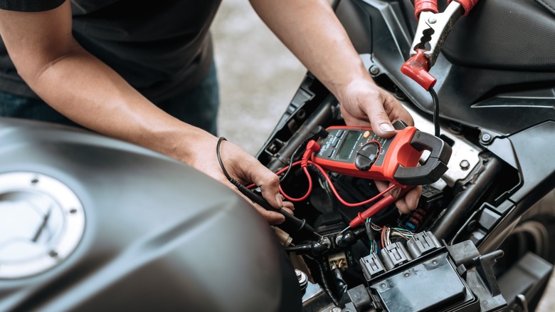 Zoomed in image of a person wiring a bike