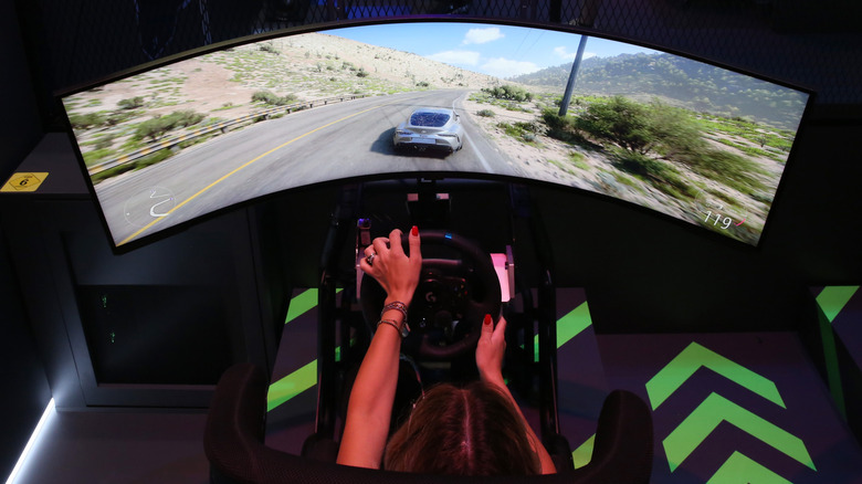 Gamer sim-racing on a curved monitor