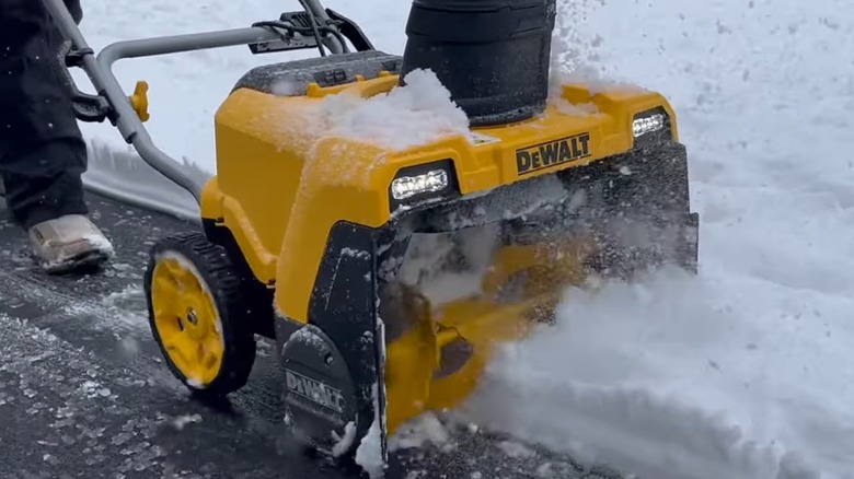 A DeWalt snow blower moving through snow.