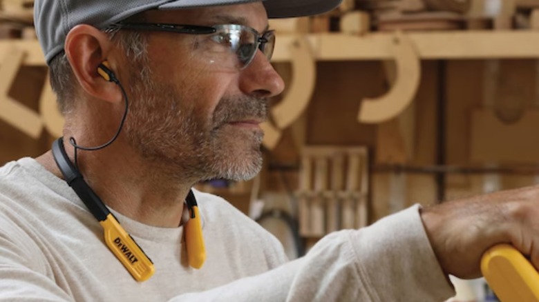 A person wearing dewalt jobsite pro wireless earphones