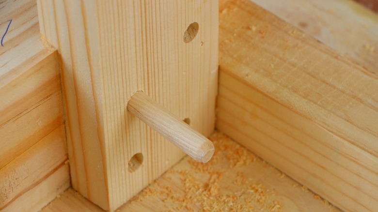woodwork being assembled with dowel joint and hole