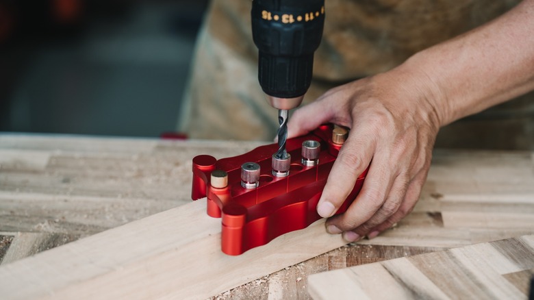 Woodowrker drilling joint into wood piece