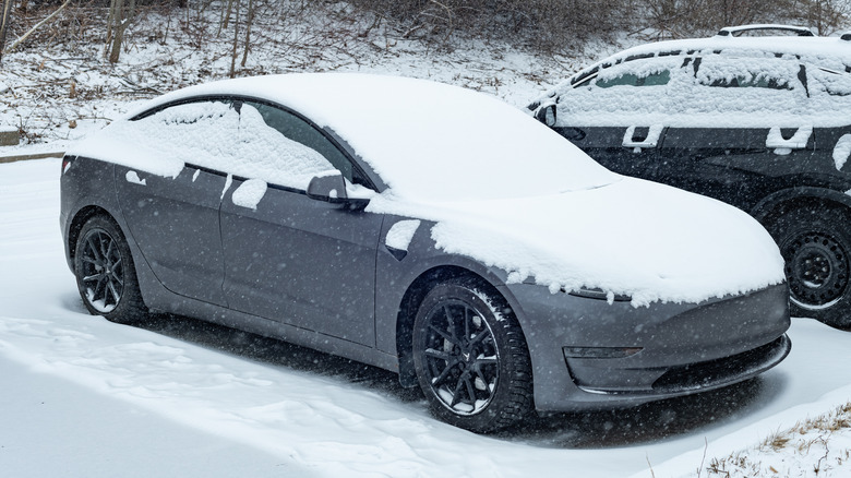 Tesla car covered in snow
