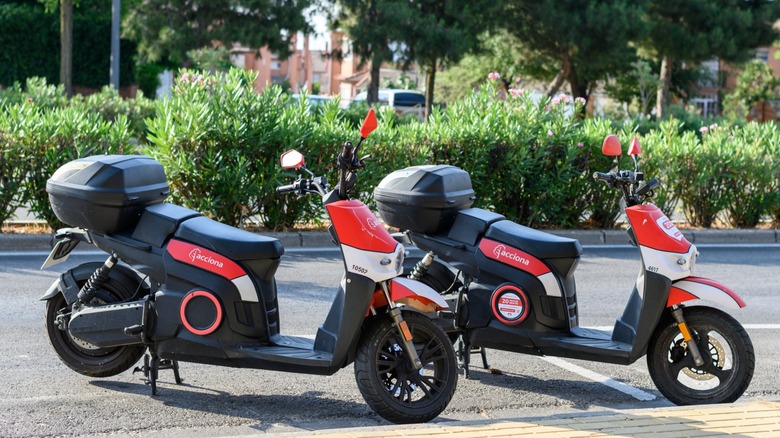 Two electric motorcycles parked on the street