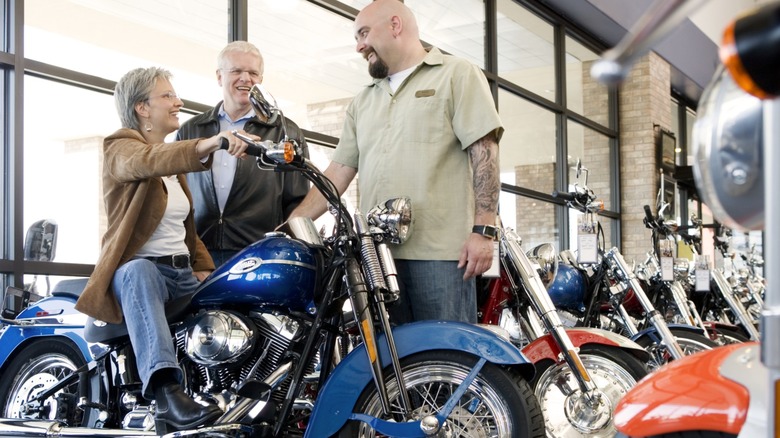 A woman trying out a bike at a dealership