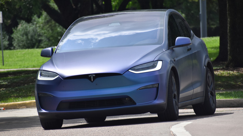 A Tesla Model X driving down a road