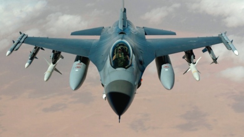 F-16 flying over desert terrain
