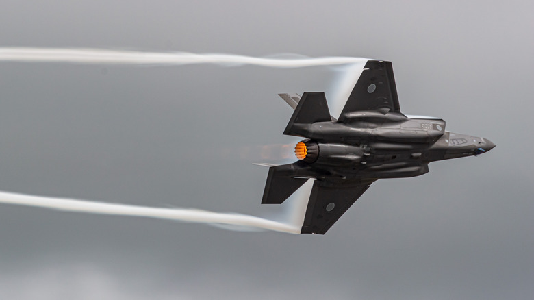 Vaper coming from fighter jet wing tips as it flies