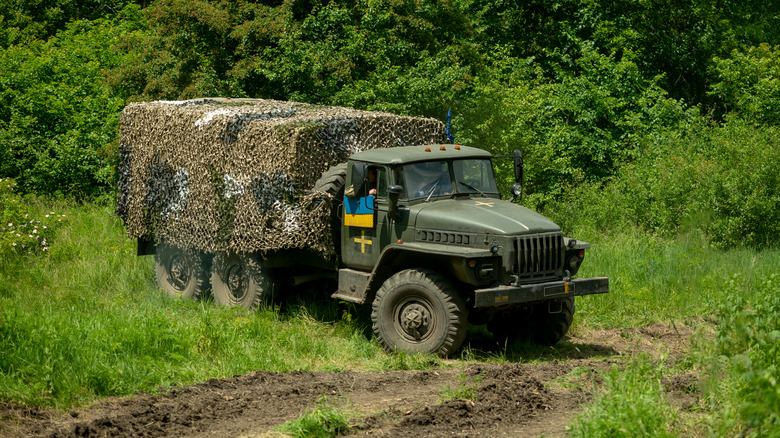 Military truck following dirt path