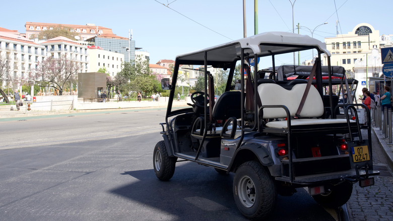 A golf cart parked on a street in Portugal