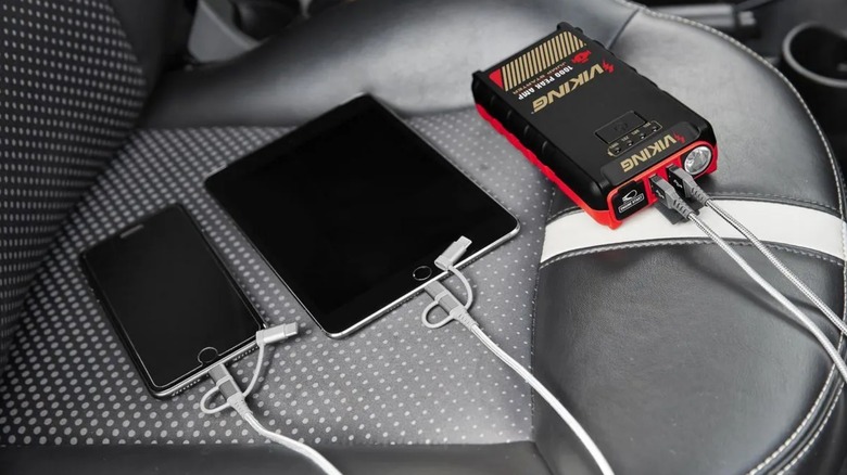 a harbor freight viking jump starter being used to charge mobile devices