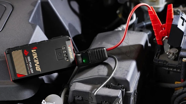 a harbor freight viking jump starter connected to a car battery