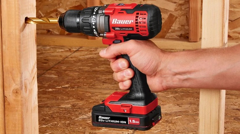 A person using a Bauer 20V drill driver