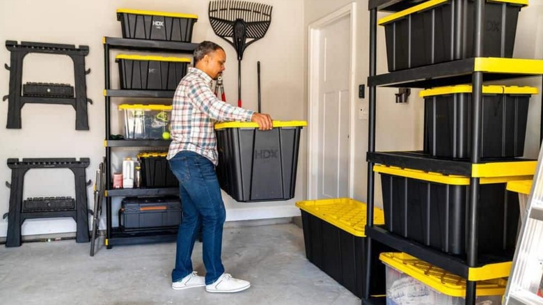 a person using a series of home depot hdx storage containers