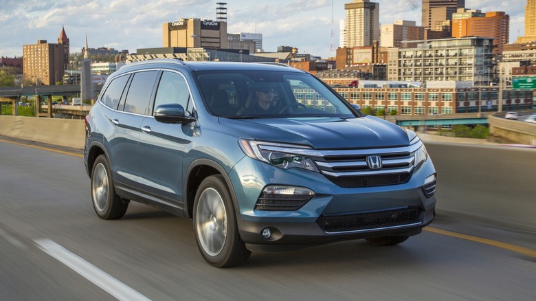 2016 Honda Pilot In Blue Driving Through The City