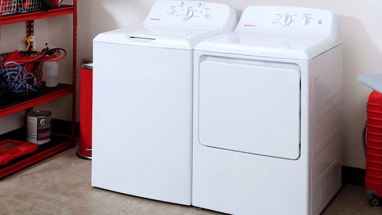 A Hotpoint washer and dryer in a laundry room