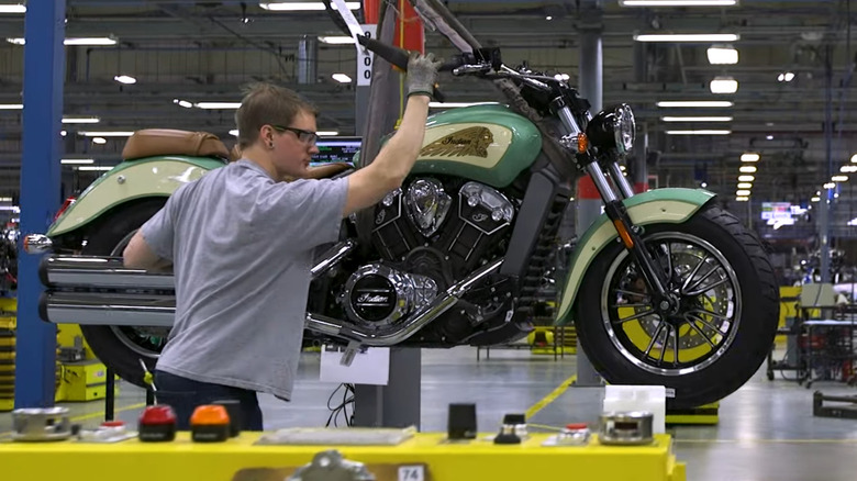 Indian Motorcycle staff pushing a bike at the Spirit Lake, Iowa facility