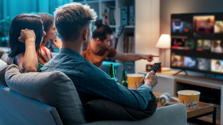 People watching a television set on their couch