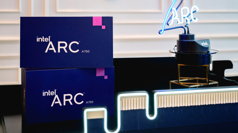Intel Arc A750 GPU boxes next to a neon sign
