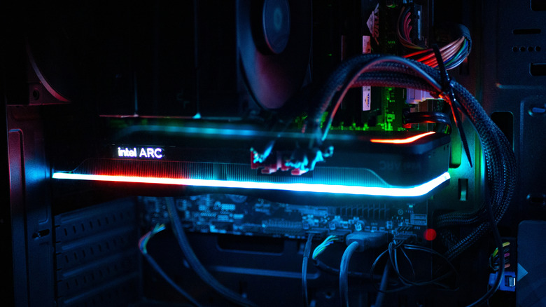 Intel graphics card with RGB lights, attached to a motherboard